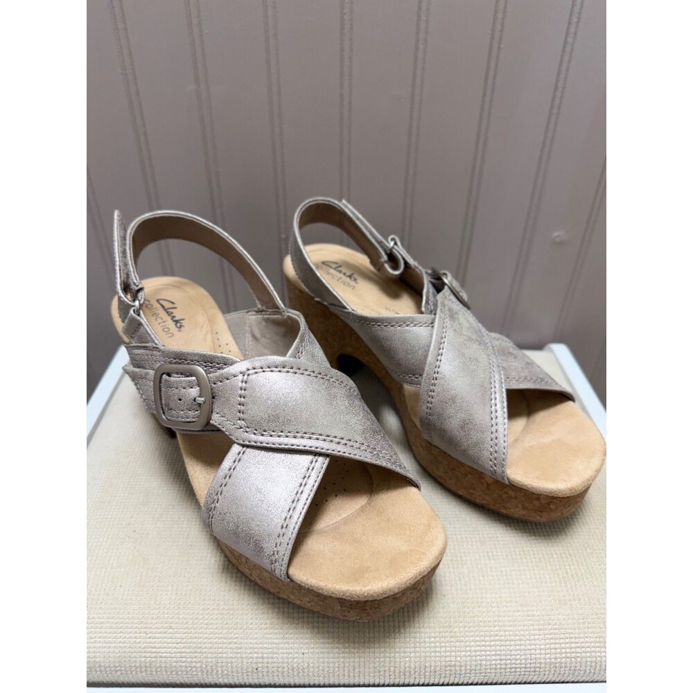 Clarks Nerisa sandals featuring a pewter-colored metallic upper and a cork wedge